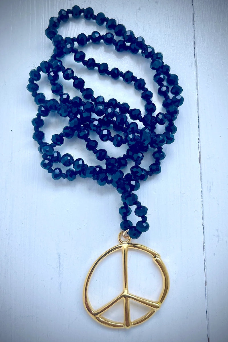 black beaded necklace with peace sign 